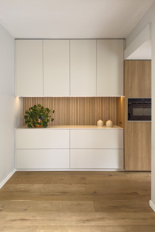 Keuken op maat met houten latjes en beige deurtjes.