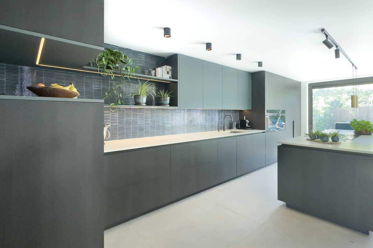 Maatwerk keuken in woning Amersfoort met kookeiland en hoge kastenwand